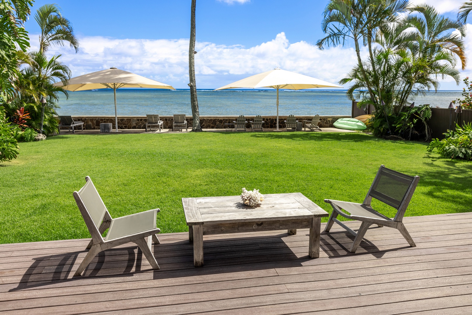 Honolulu Vacation Rentals, Moana Lani - Main House - Two deck chairs, one low table, and nothing between them and the ocean but lawn.