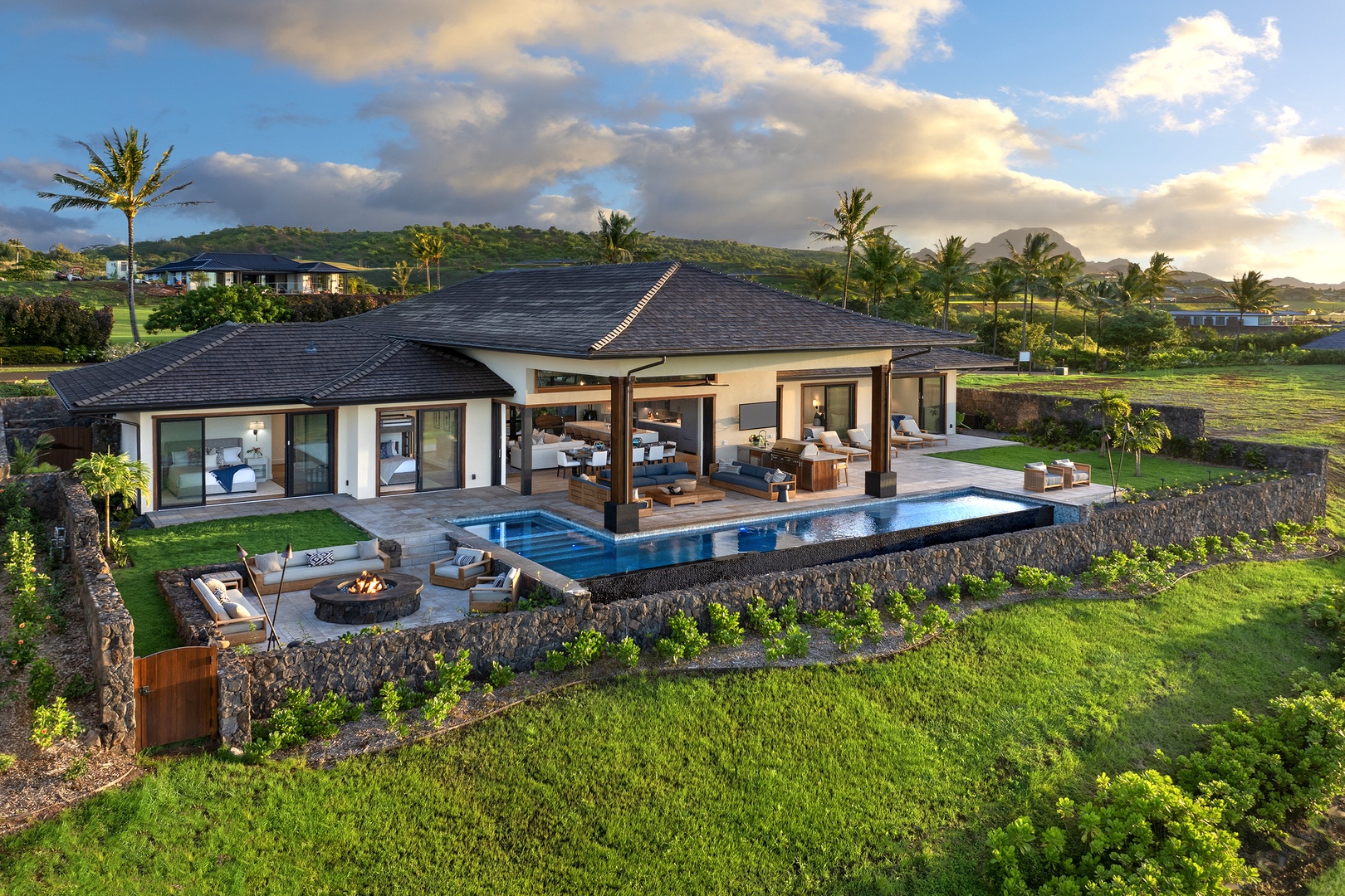 Koloa Vacation Rentals, Ke Kai Nui at Kukuiula - Aerial view of the property showcasing its stunning infinity pool, outdoor spaces, and picturesque surroundings.