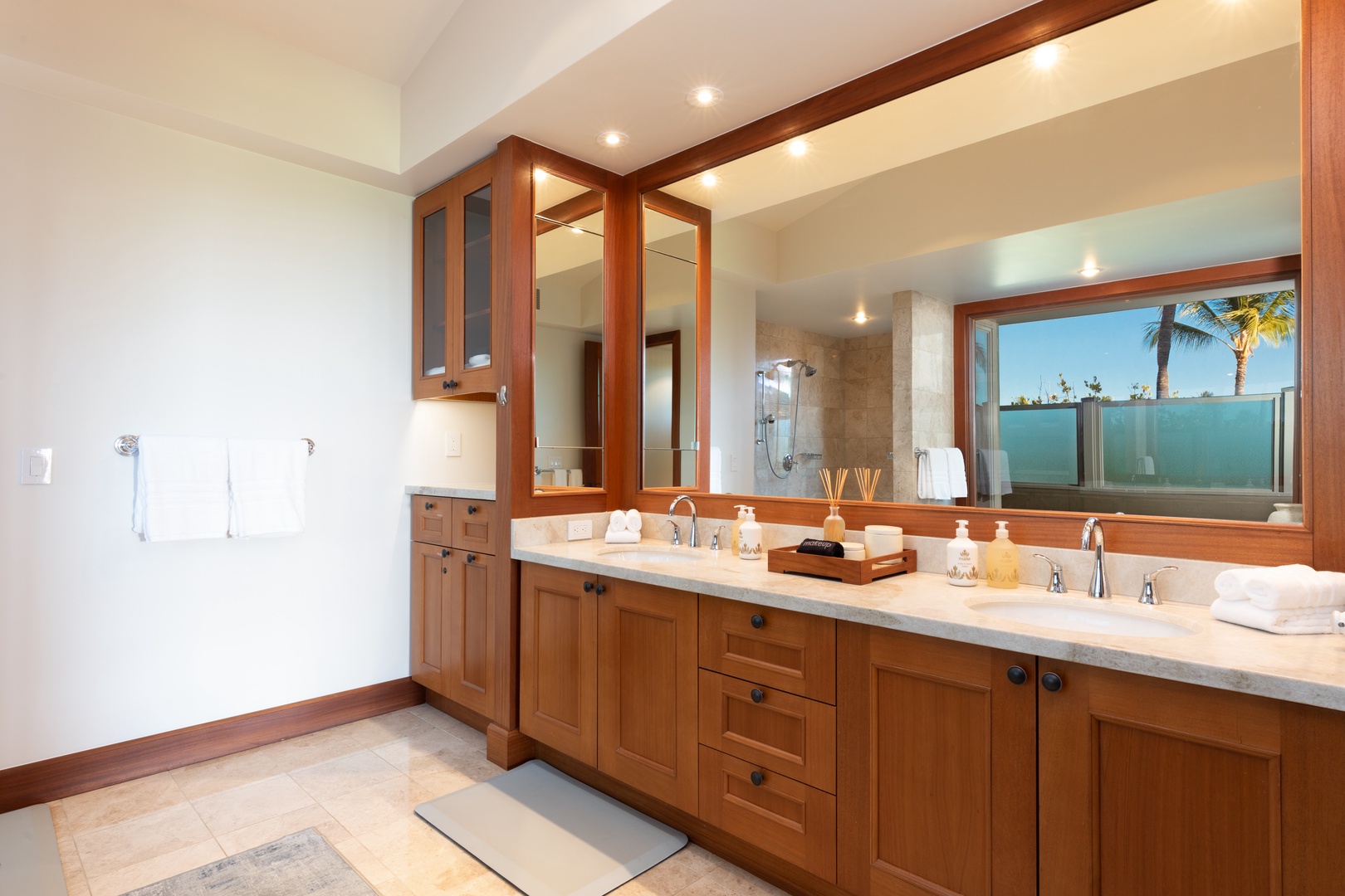 Kailua Kona Vacation Rentals, 3BD Waiulu Villa 111D at Hualalai Resort - Elegant bathroom with dual sinks, ample counter space, and warm wood cabinetry.