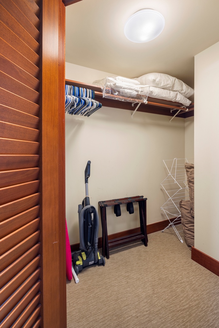 Kapolei Vacation Rentals, Ko Olina Beach Villas B609 - Your spacious walk-in closet features rich wood shelving, hanging space for your wardrobe, and thoughtful storage solutions to keep your belongings organized.