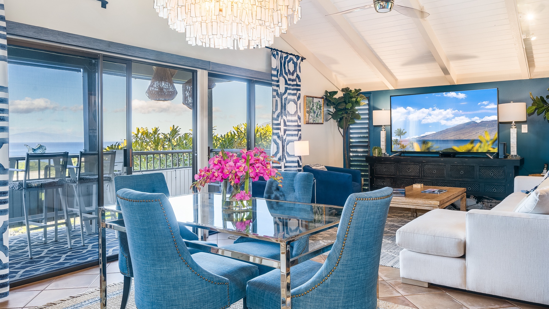 Kihei Vacation Rentals, Wailea Ekolu 1106 - The elegant dining area is perfect for intimate meals, with vibrant blue accents and beautiful views through floor-to-ceiling windows, creating an inviting space to enjoy your surroundings.