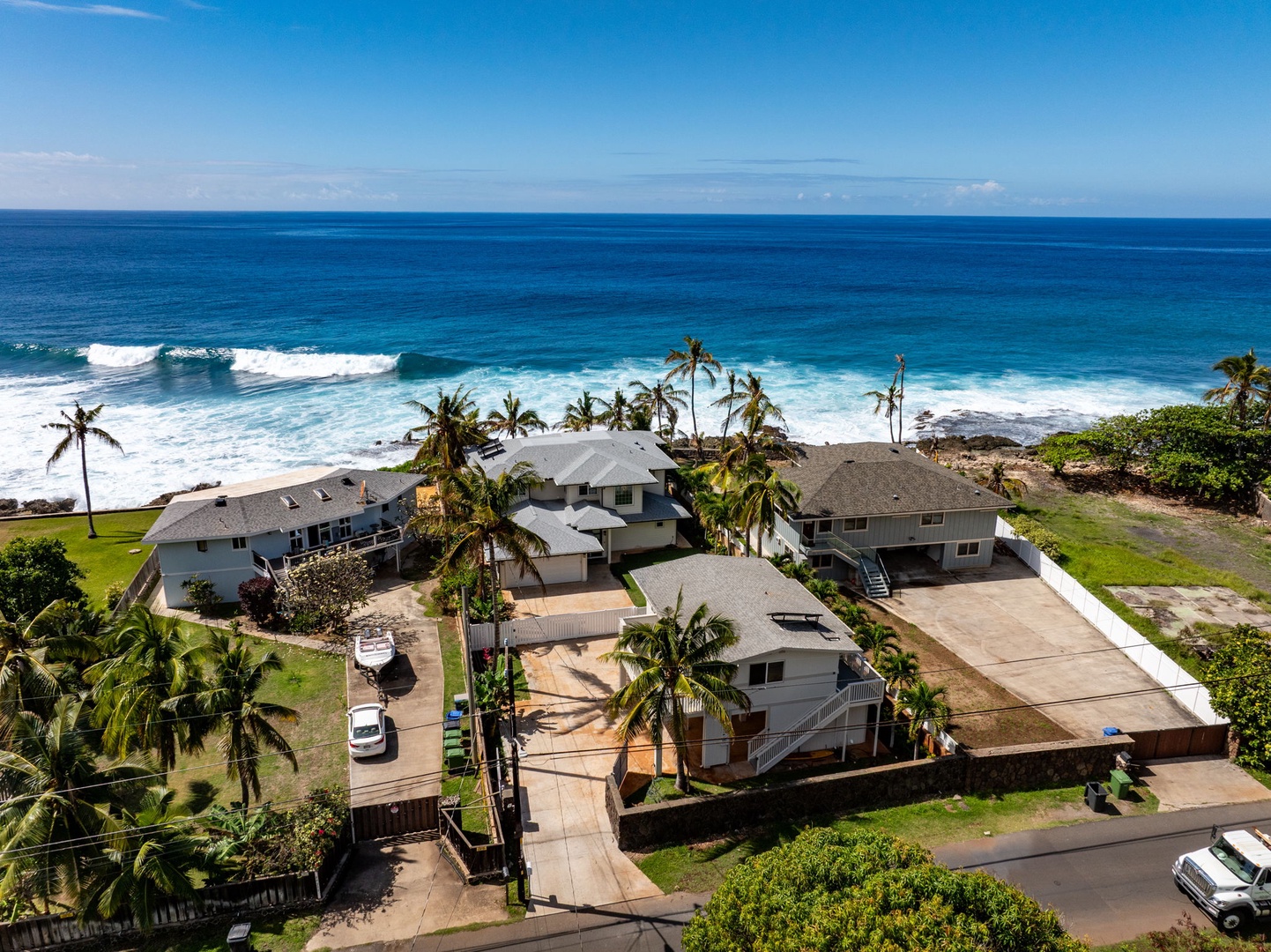 Waianae Vacation Rentals, Oceanfront Luxury Dream Estate - This close-range drone angle highlights proximity to the shore and the home’s expansive backyard.