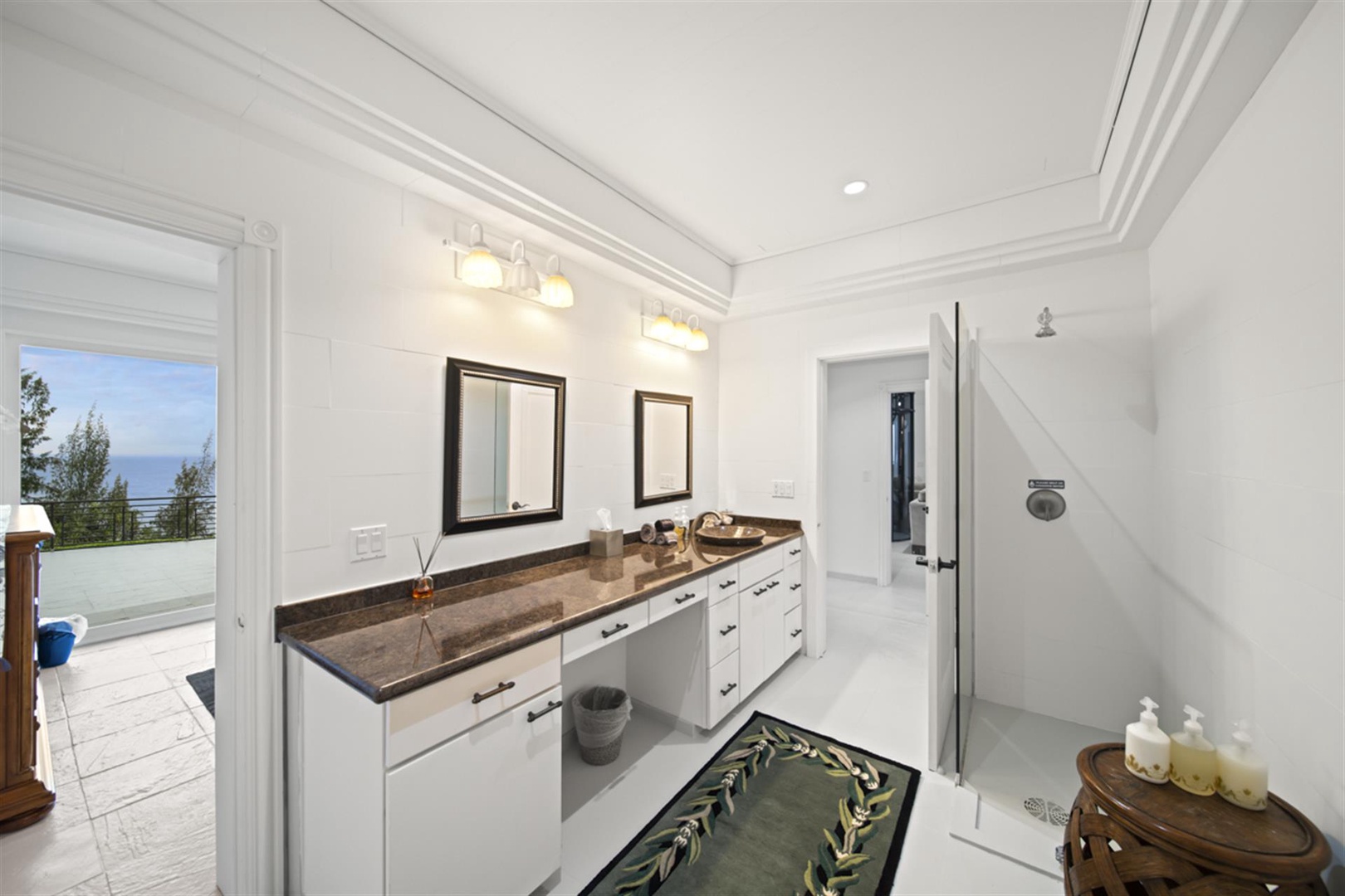 Ninole Vacation Rentals, Waterfalling Estate** - Shared bathroom with ample vanity space.