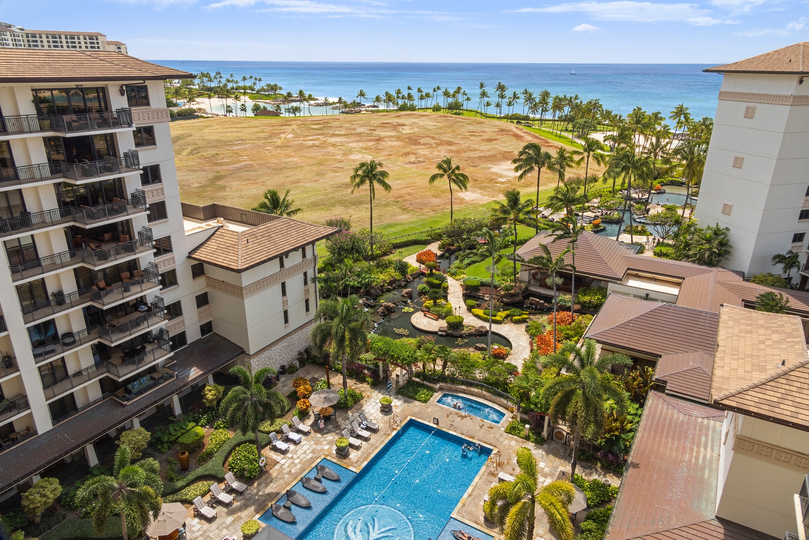 Kapolei Vacation Rentals, Ko Olina Beach Villas O1001 - Resort pool view from the lanai with a glimpse of the ocean