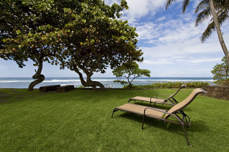 Haleiwa Vacation Rentals, Sunset Point Hawaiian Beachfront** - Outdoor loungers while being soaked up with the island breeze.