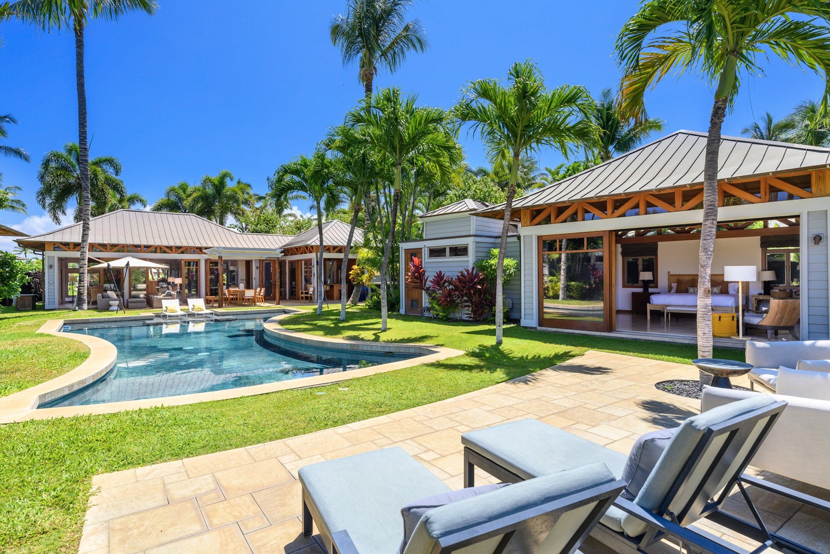 Kamuela Vacation Rentals, 3BD Na Hale 3 at Pauoa Beach Club at Mauna Lani Resort - Sun loungers by the poolside offering a perfect way to relax and enjoy the island breeze.