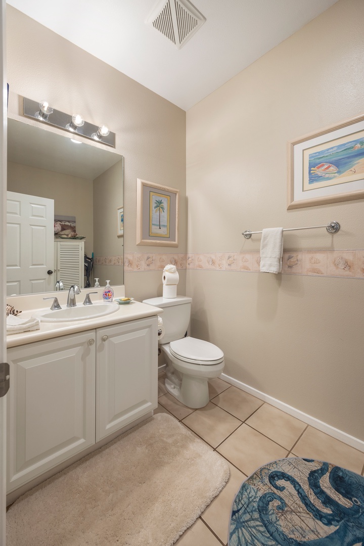 Step into your bright bathroom with coastal charm, featuring fresh towels and thoughtful touches for your comfort.