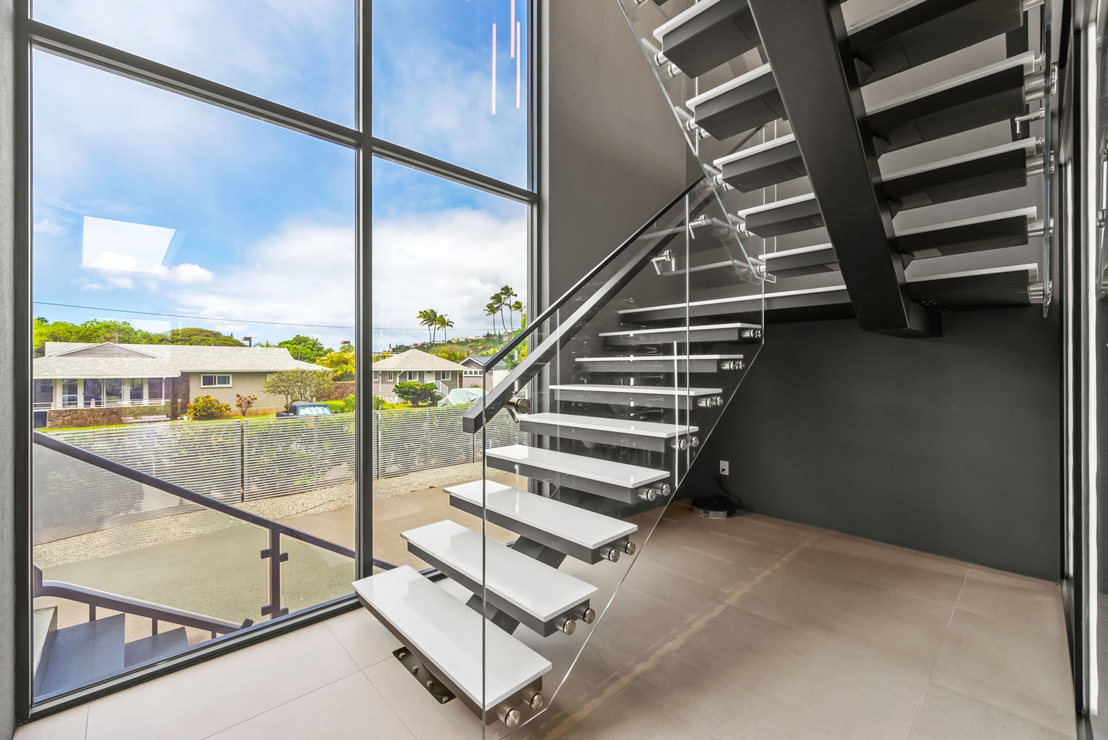 Honolulu Vacation Rentals, Ocean Villa 3 Bedroom - Floating staircase framed by floor-to-ceiling windows and natural light.