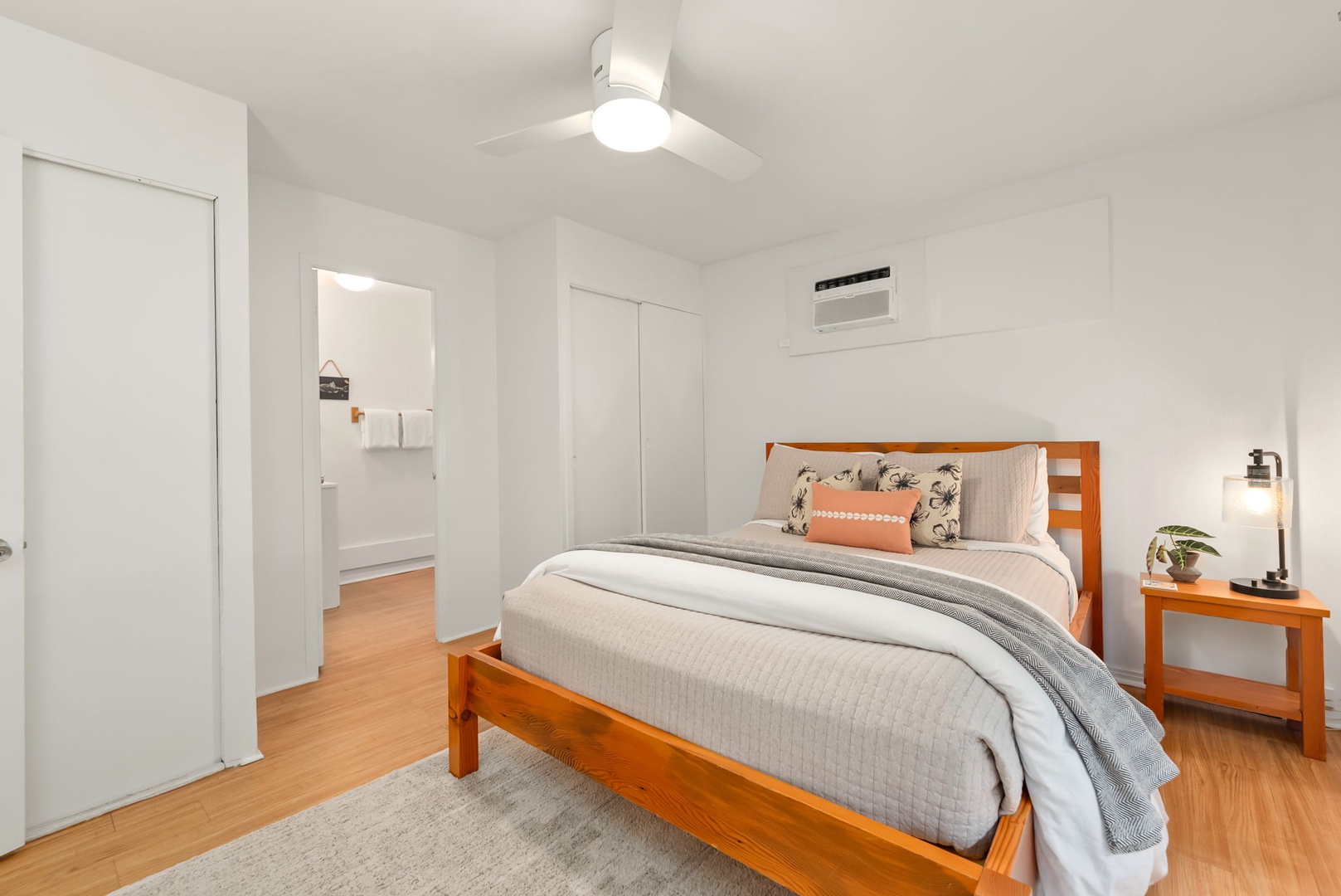 Honolulu Vacation Rentals, Ho'okipa Villa - Drift off in this serene bedroom with your cozy bed, sleek air conditioning, and gentle ceiling fan overhead—your perfect retreat after a day of exploring.