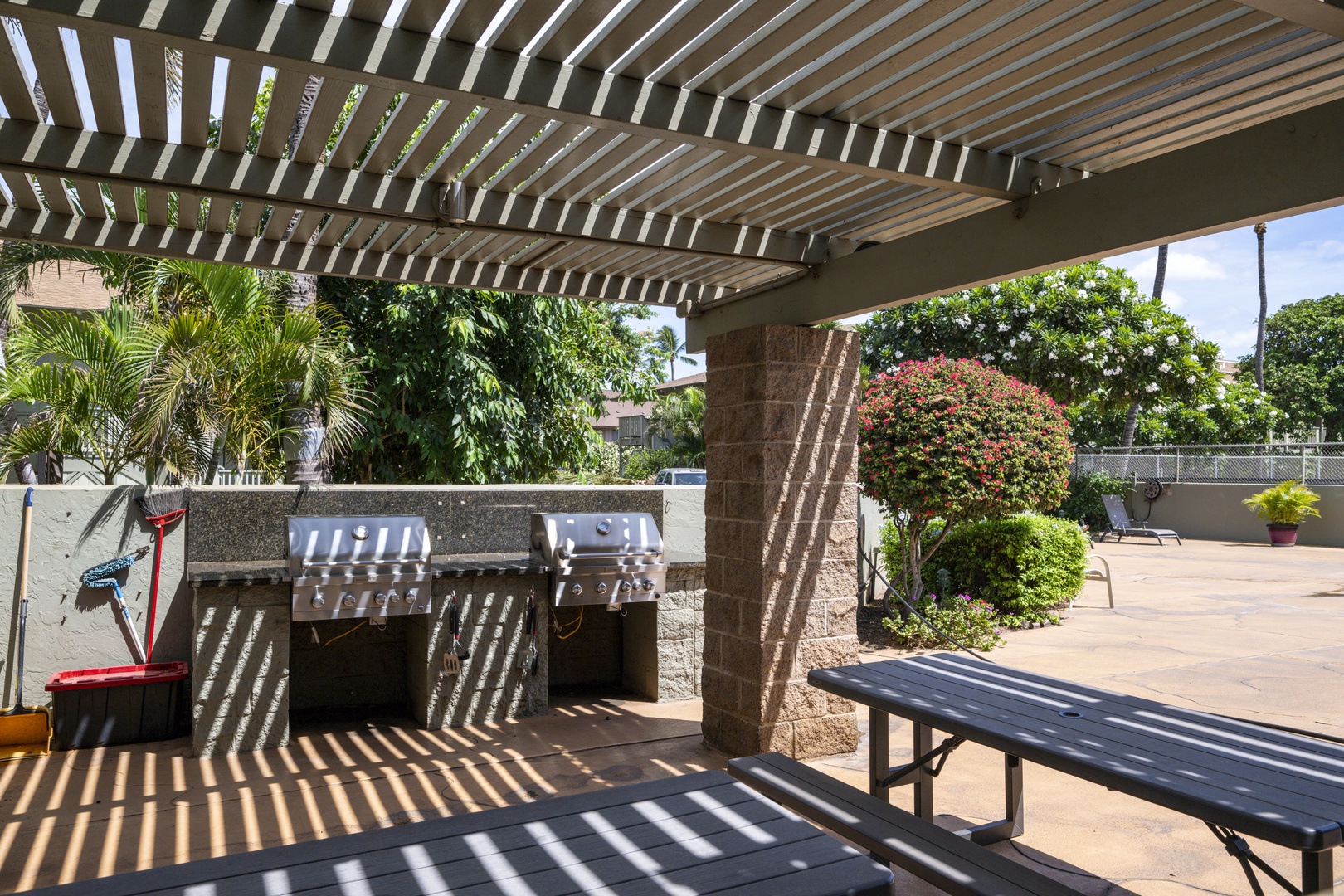 Kihei Vacation Rentals, Kihei Bay Surf B212 - Outdoor kitchen awaits under the pergola, where you'll grill fresh meals while tropical breezes dance through the palms.