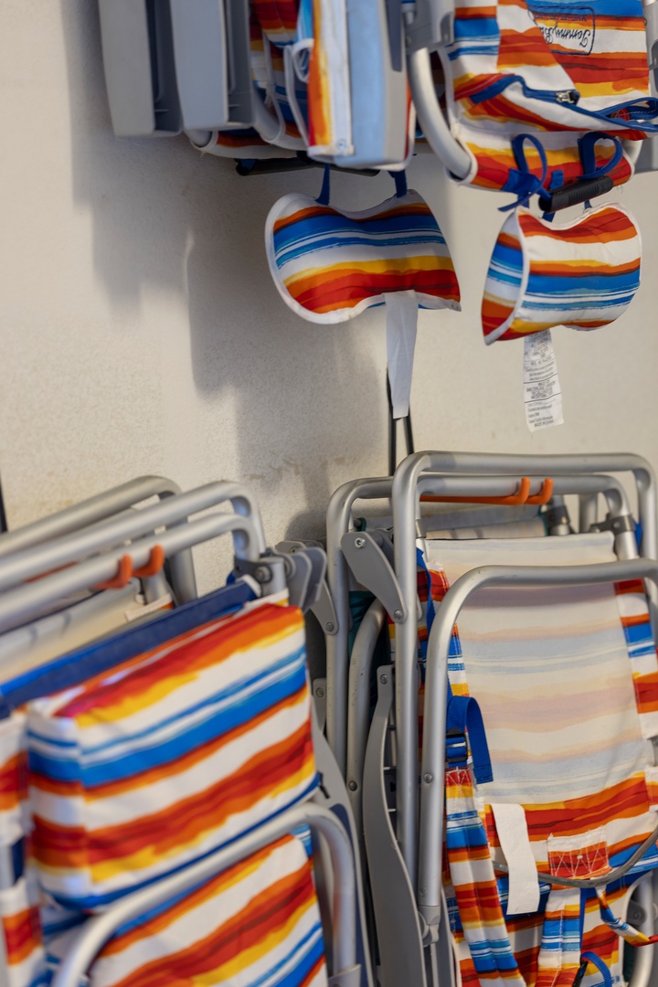 Stack your colorful beach chairs with ease using these convenient storage racks, keeping your outdoor space organized and ready for relaxation.