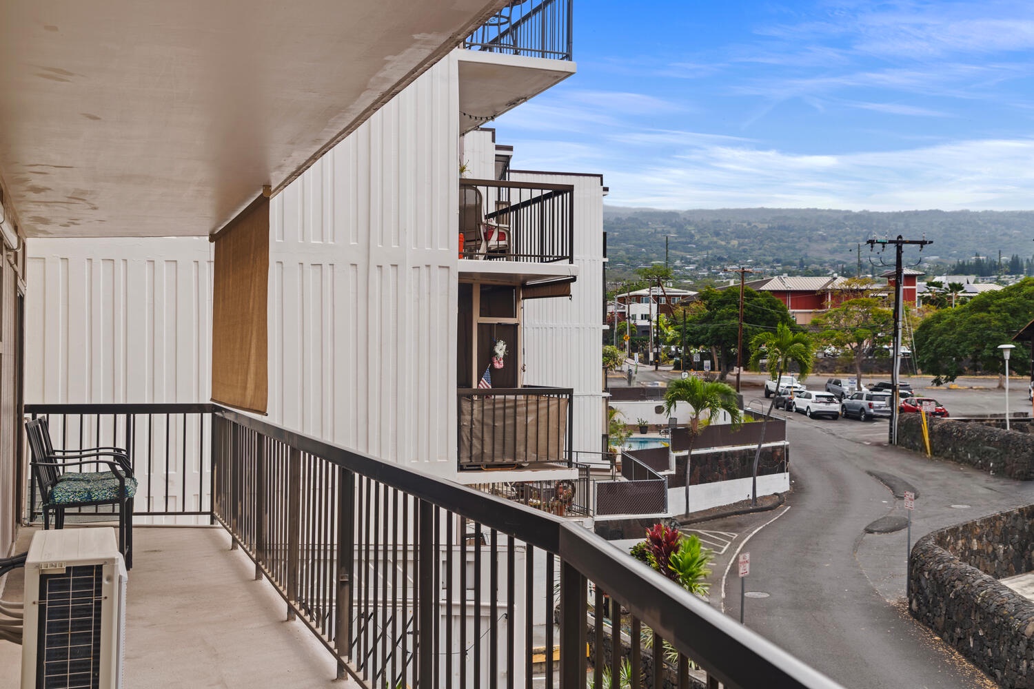 Kailua Kona Vacation Rentals, Kona Plaza 201 - Step onto your private lanai and soak in panoramic views of the charming neighborhood below, where tropical landscapes meet local life.