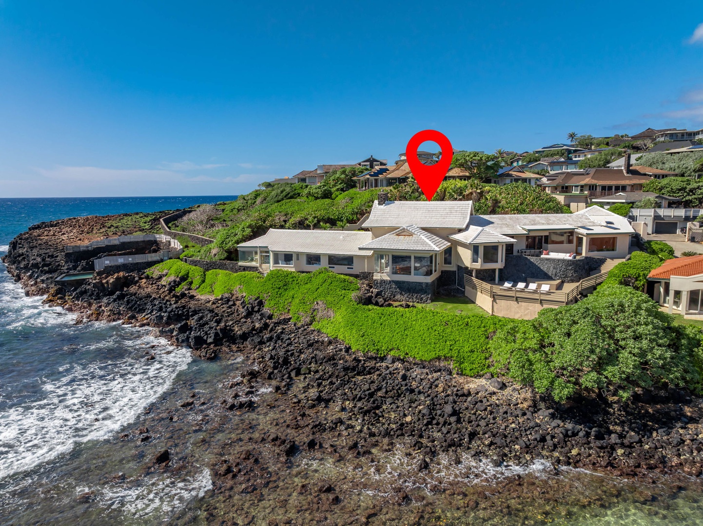 Honolulu Vacation Rentals, Black Point Ocean Villa - Stunning oceanfront villa perched on dramatic lava rocks with waves crashing nearby. Luxurious coastal retreat surrounded by lush tropical vegetation.