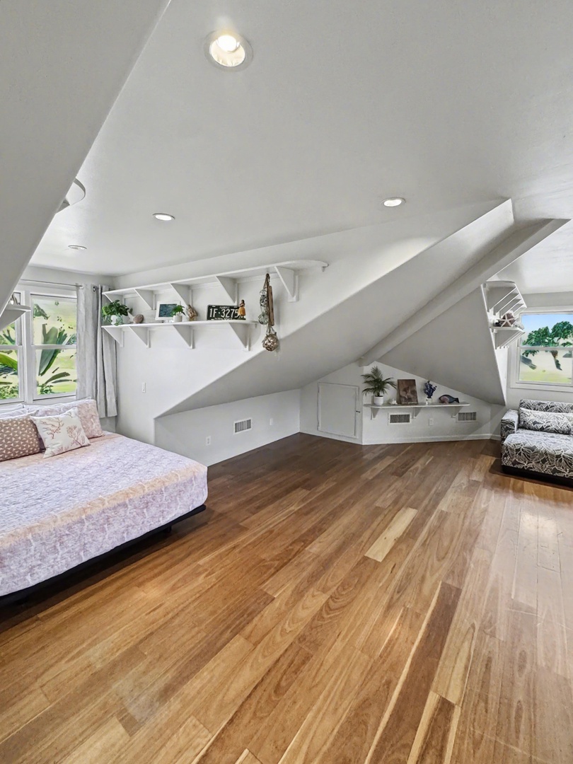 Kailua-Kona Vacation Rentals, Hahalua Bay Villa - Your charming loft offers cozy sloped ceilings, warm wood floors, built-in storage nooks, and bright windows overlooking lush greenery.