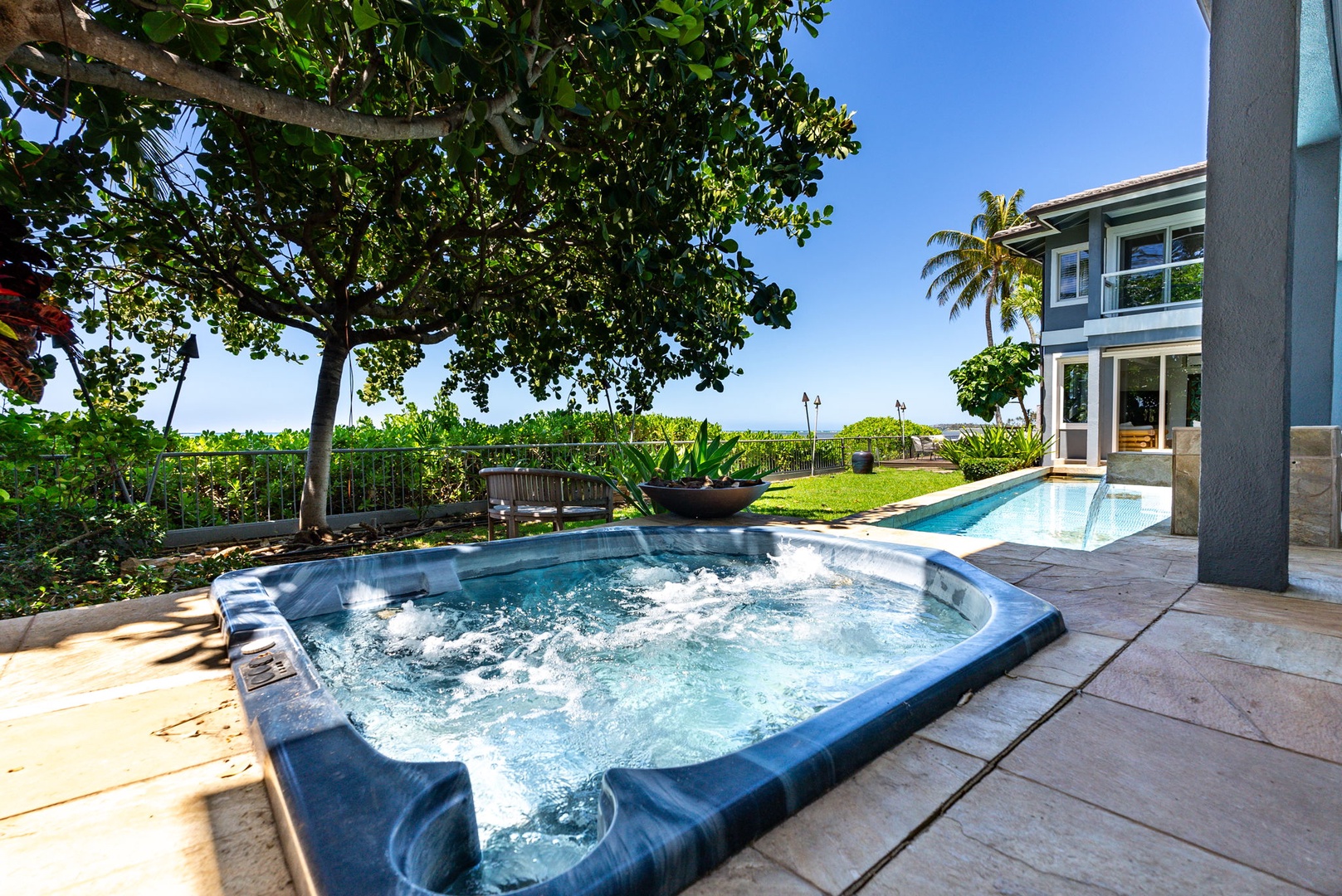 Honolulu Vacation Rentals, Wailupe Beachfront Getaway - Enjoy a relaxing soak in the outdoor hot tub while taking in the tropical views.