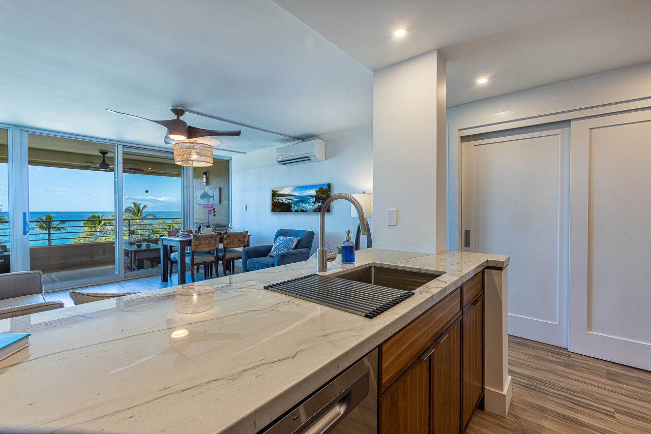 Kihei Vacation Rentals, Kamaole Beach Royal 610 - The kitchen sink faces straight to the ocean past the sliders.