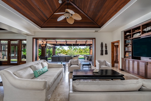 Kamuela Vacation Rentals, Canoe House & Beach Walker at Champion Ridge - The expansive living area that opens directly to the lanai, a perfect spot for gathering and entertainment.