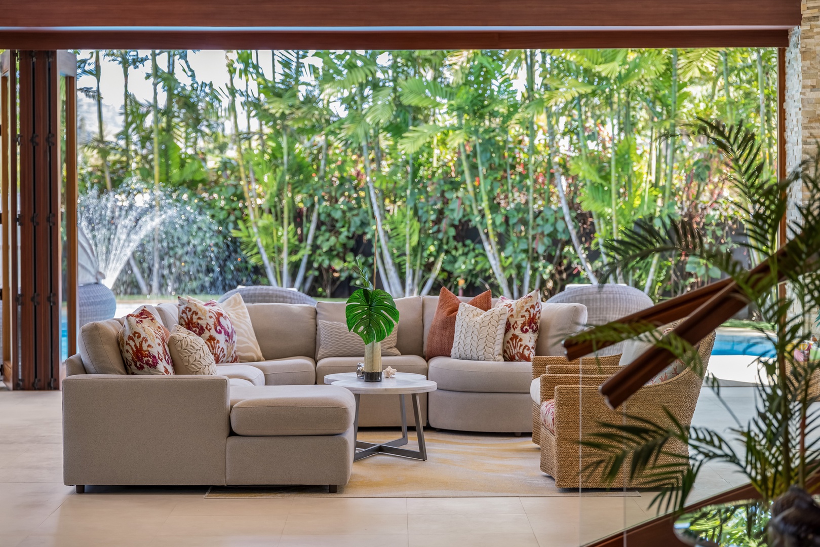 Honolulu Vacation Rentals, Kahala Grand Splendor - Tropical backdrop in the living area poolside with a tranquil pool's water feature.