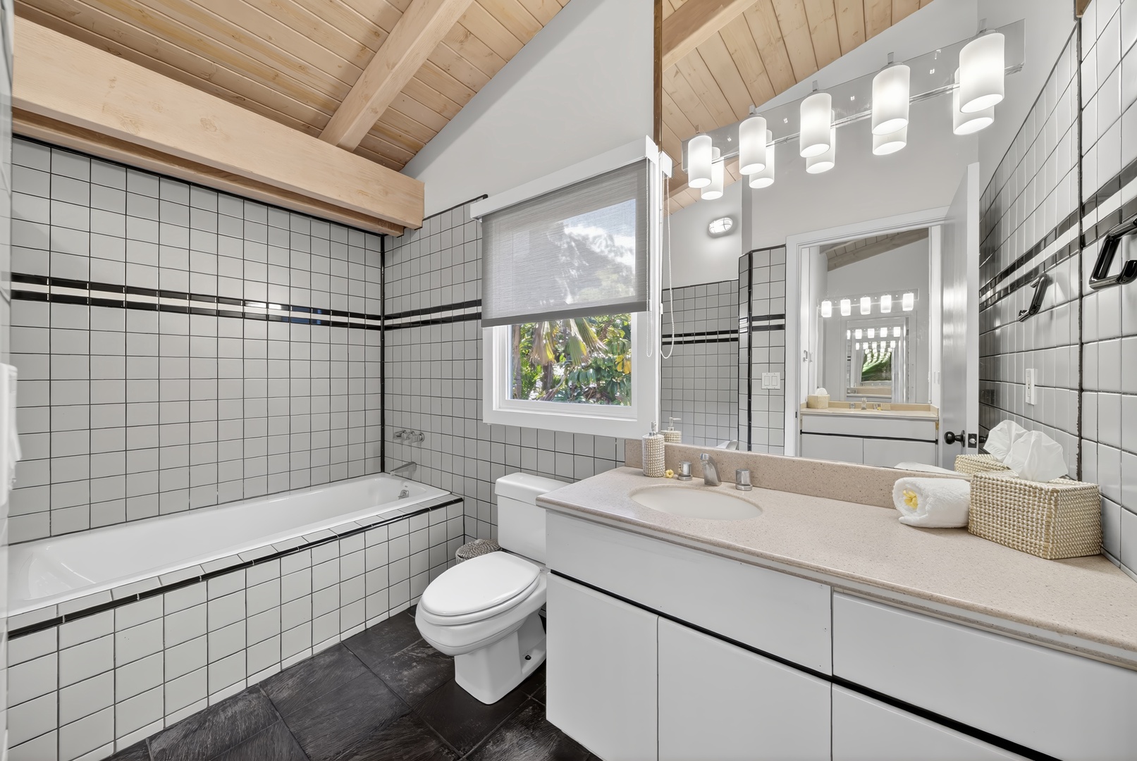 Haleiwa Vacation Rentals, Sunset Beach Hideaway - Refresh in the bright ensuite bathroom featuring double sinks and classic tile finishes.