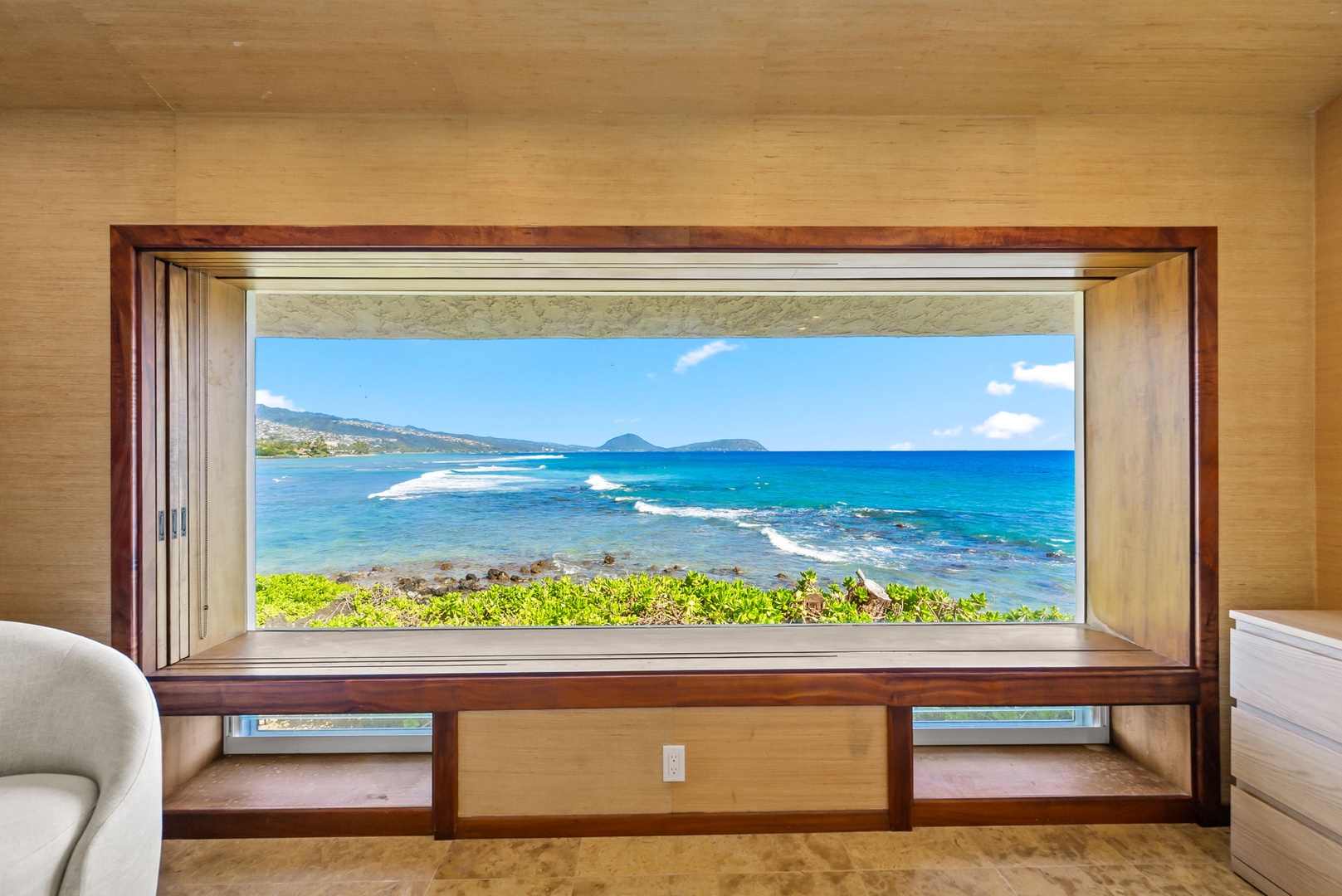 Honolulu Vacation Rentals, Black Point Ocean Villa - Expansive picture window, where turquoise waters and distant islands create your perfect morning backdrop.
