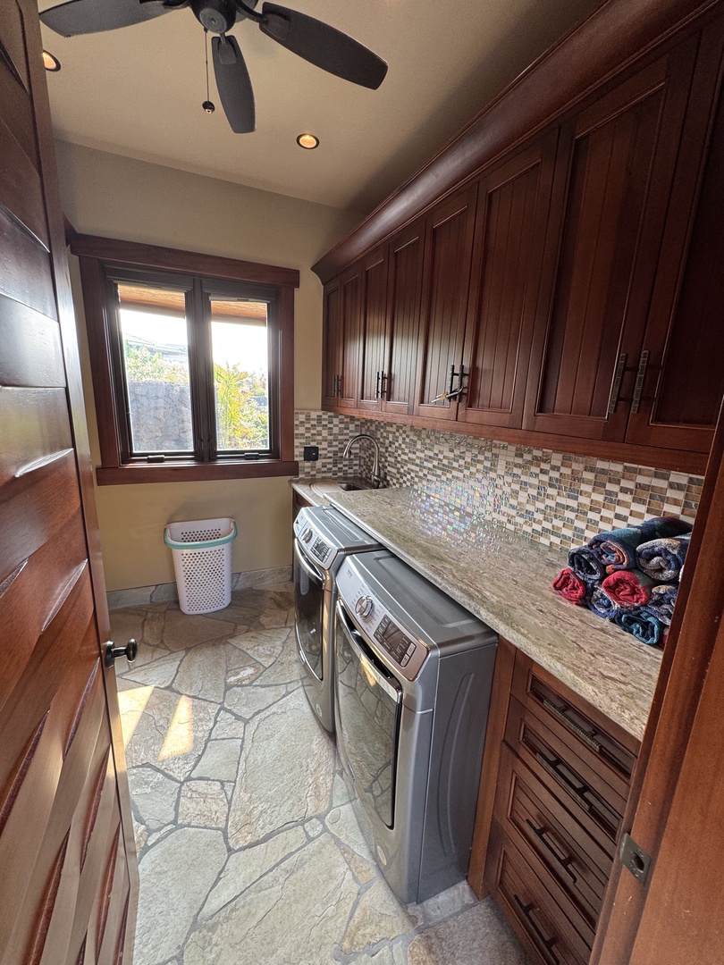 Kamuela Vacation Rentals, Hale Konane - A fully equipped laundry room with a washer, dryer, and ample storage for convenience.