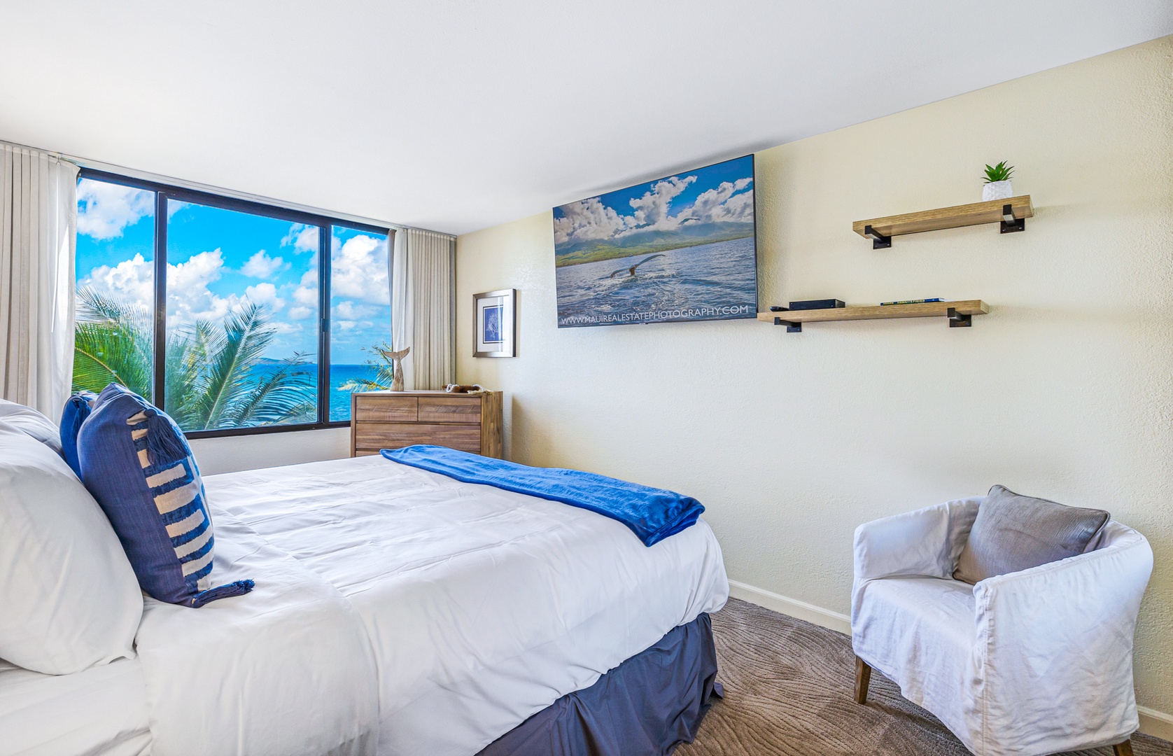 Lahaina Vacation Rentals, Kaanapali Shores 502 - The bedroom offers a serene ocean view, complemented by a comfortable bed and a mounted television for a relaxing escape