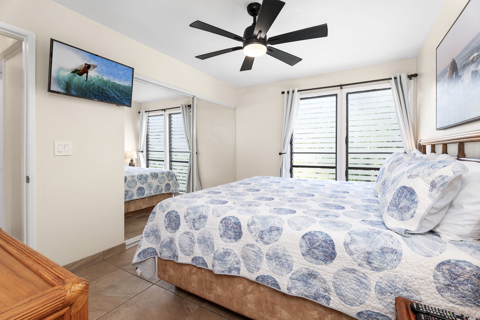 Kailua Kona Vacation Rentals, Sea Village 4213 - Spacious primary suite with flat-screen TV, cooling cross-breeze windows, and tranquil decor.