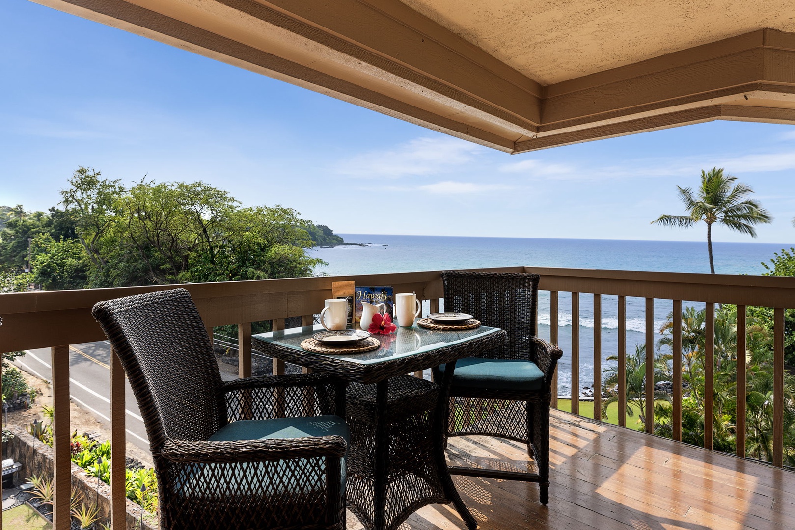 Kailua Kona Vacation Rentals, Royal Kahili 401A - Scenic lanai dining area with seating for four, overlooking lush greenery and ocean views.