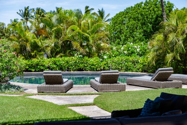 Kamuela Vacation Rentals, Champion Ridge 22 & 24 - Relax on one of these comfortable poolside loungers while enjoying the tropical garden views and serene ambiance.