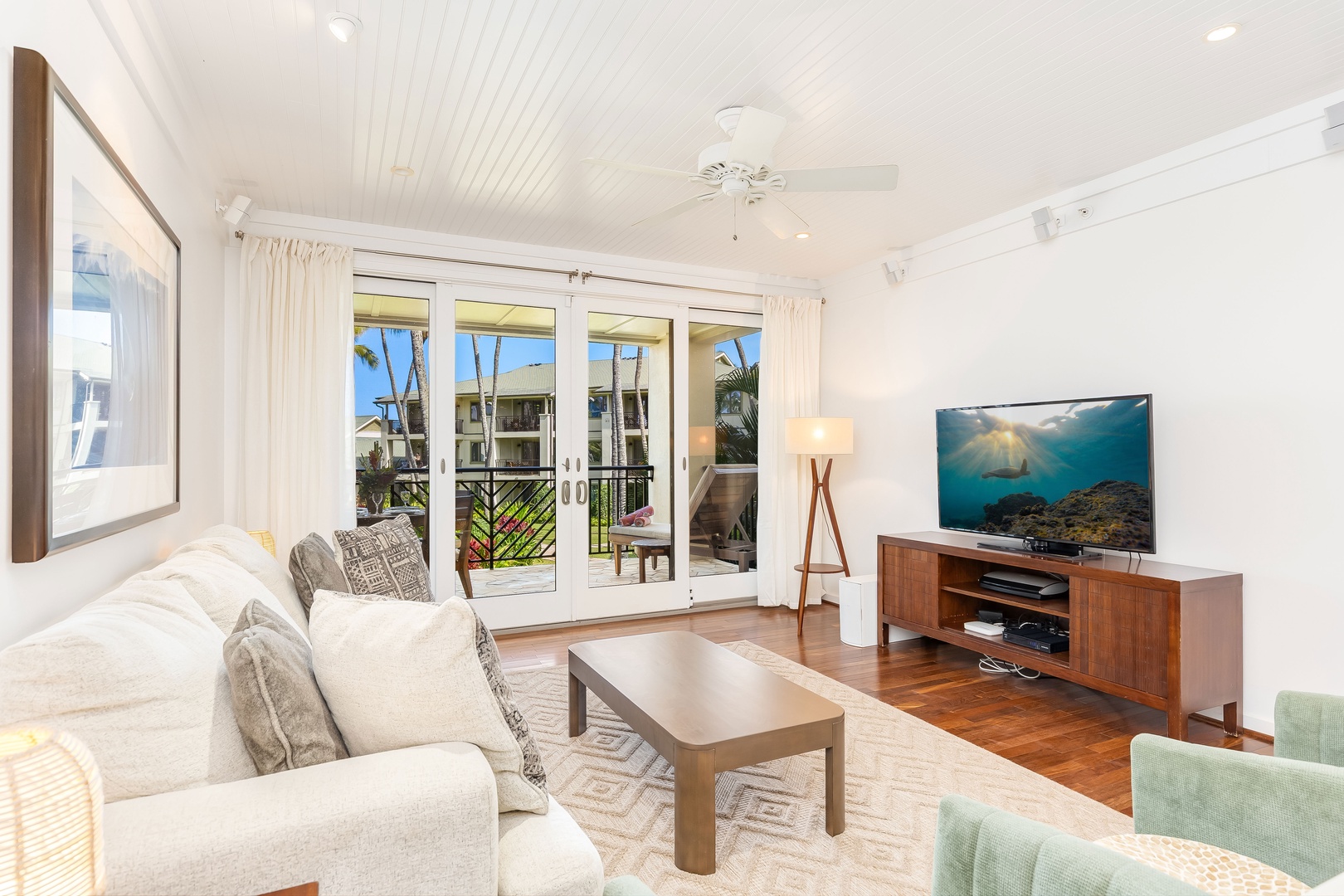 Kahuku Vacation Rentals, Turtle Bay Villas 209 - Relax in your bright living room with comfortable seating, large TV, and French doors opening to your lanai.