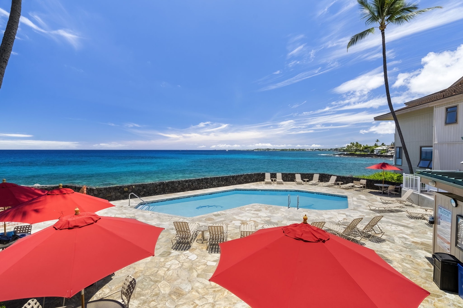 Kailua Kona Vacation Rentals, Sea Village 1105 - Oceanview hot tub and pool lounge area surrounded by tropical colors and cool sea breezes.