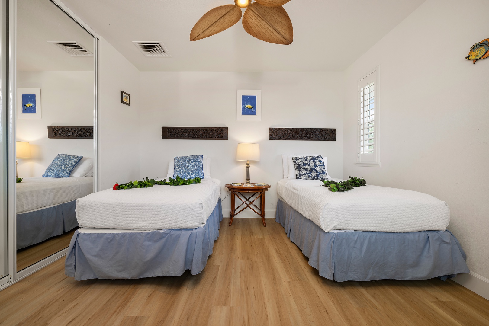 Kapolei Vacation Rentals, Ko Olina Kai 1105E - Step into your tranquil island retreat with two plush beds, tropical ceiling fan, and cheerful coastal accents that invite peaceful rest after sun-soaked days.