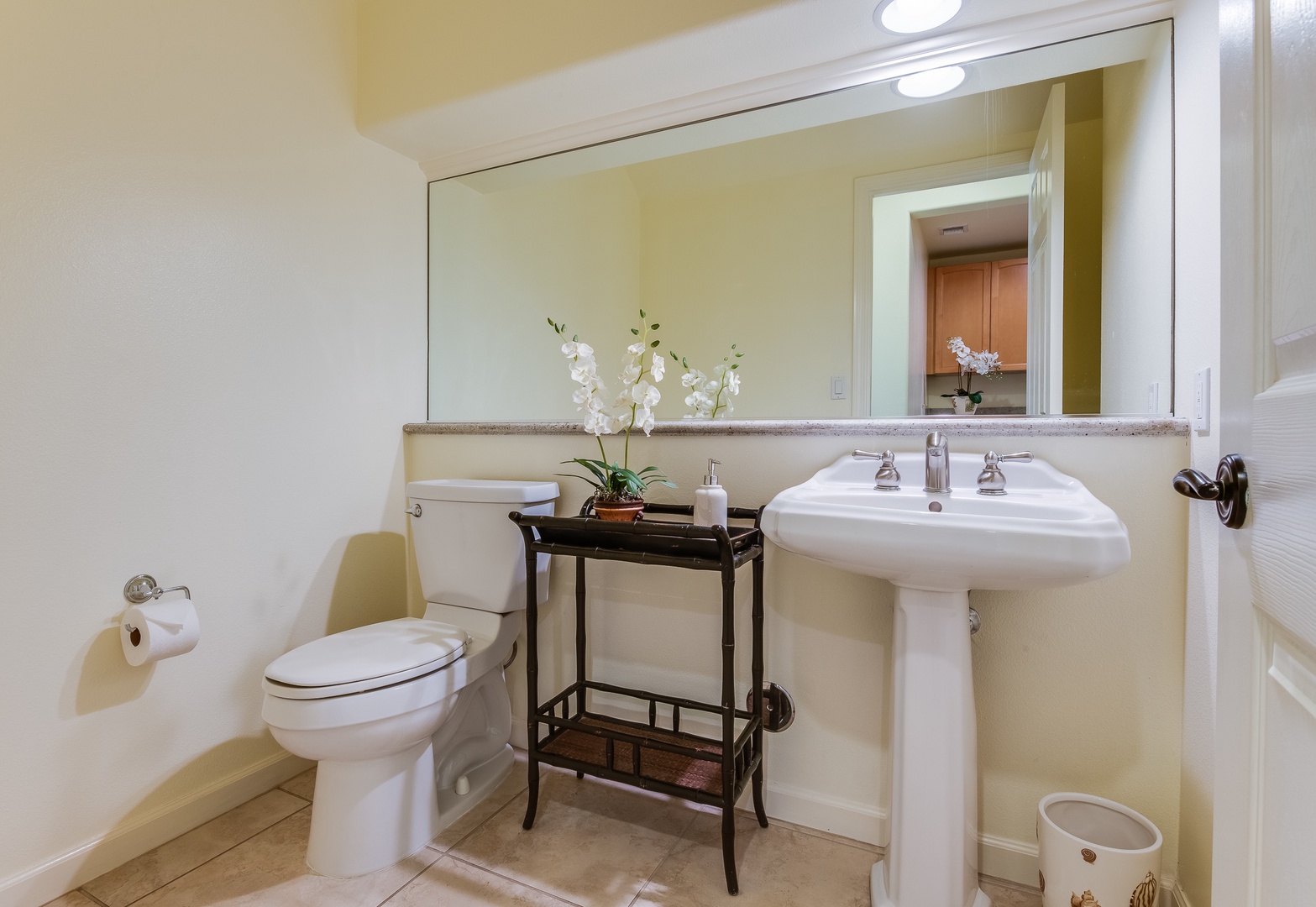 Kamuela Vacation Rentals, Mauna Lani Fairways #204 - Convenient half-bath downstairs features stylish fixtures and makes hosting easy during your Big Island stay.
