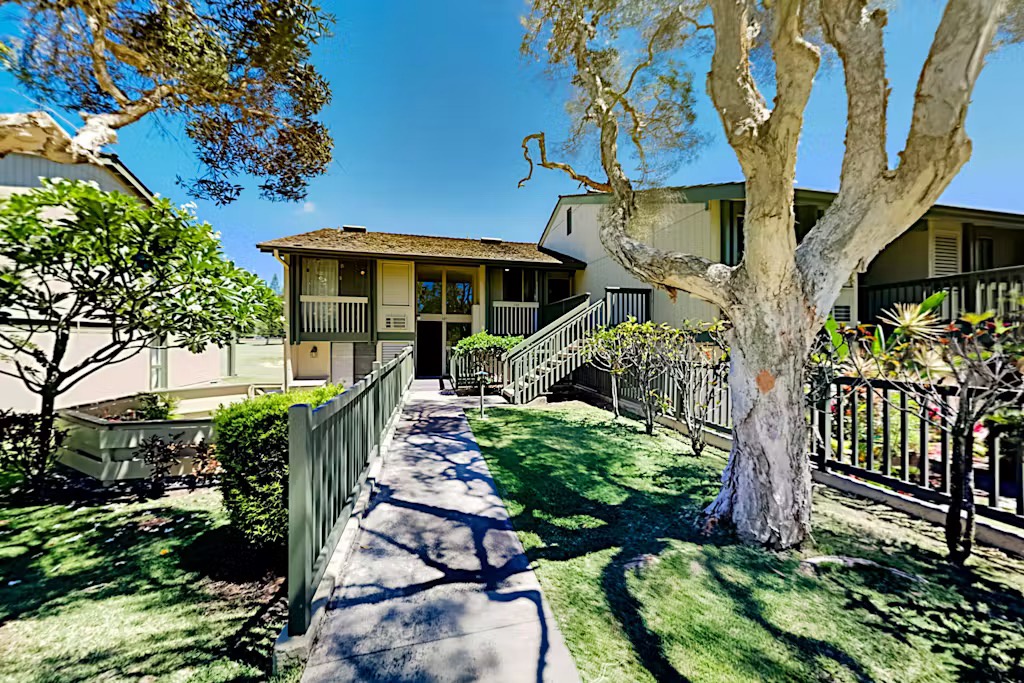 Kahuku Vacation Rentals, Kuilima Estates West #132 - Exterior view of the building with shaded walkway.