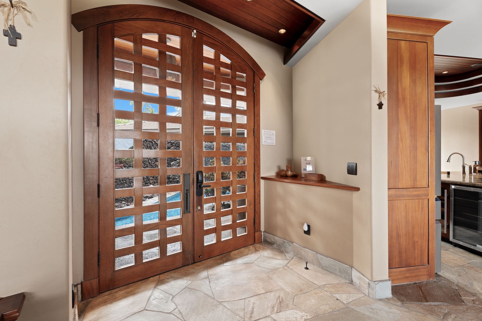 Kamuela Vacation Rentals, Hale Konane - Grand entry foyer with warm wood finishes, setting the tone for refined island living.