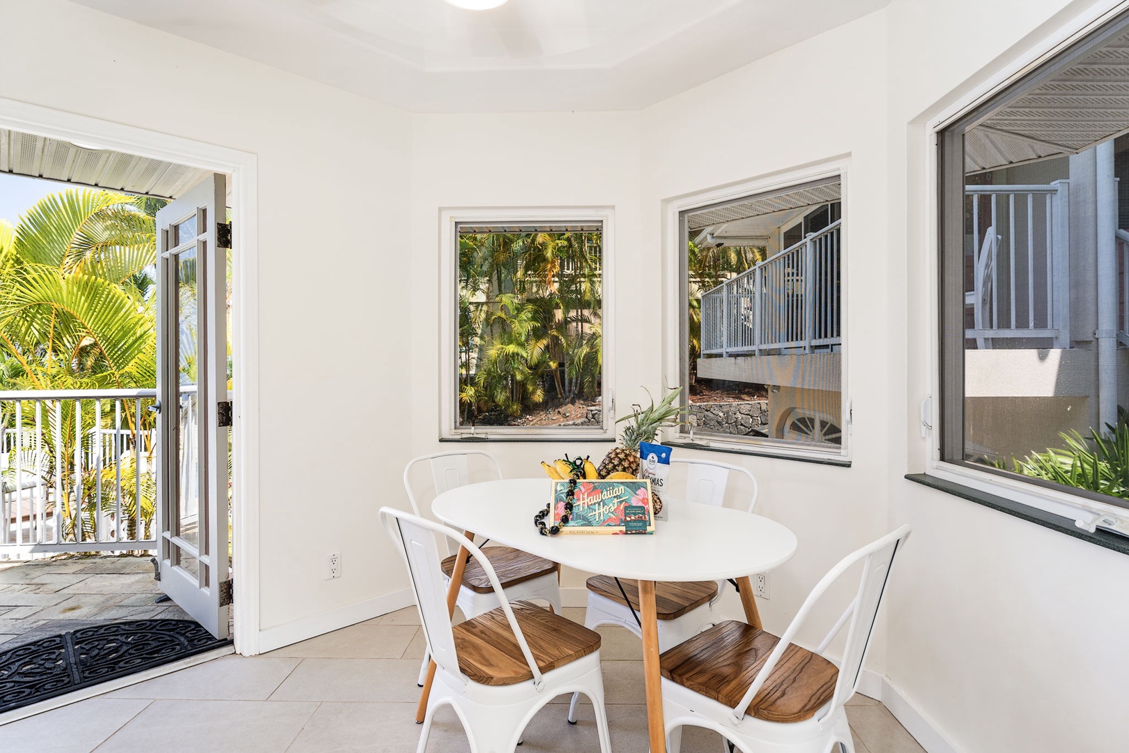 Kailua-Kona Vacation Rentals, Honu Hale - Enjoy your morning coffee at this bright dining spot with tropical garden views through large windows.