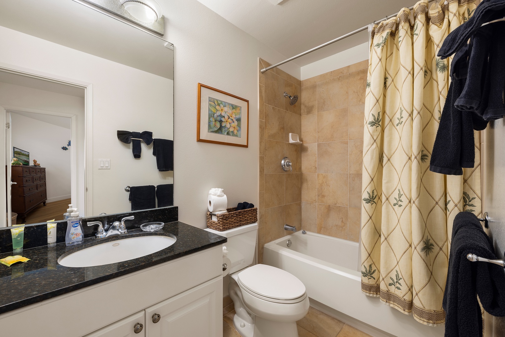 Kapolei Vacation Rentals, Ko Olina Kai 1105E - Relax in your private bathroom with a sleek vanity, fresh towels, and a soothing tub-shower combo perfect for unwinding after a day of adventures.