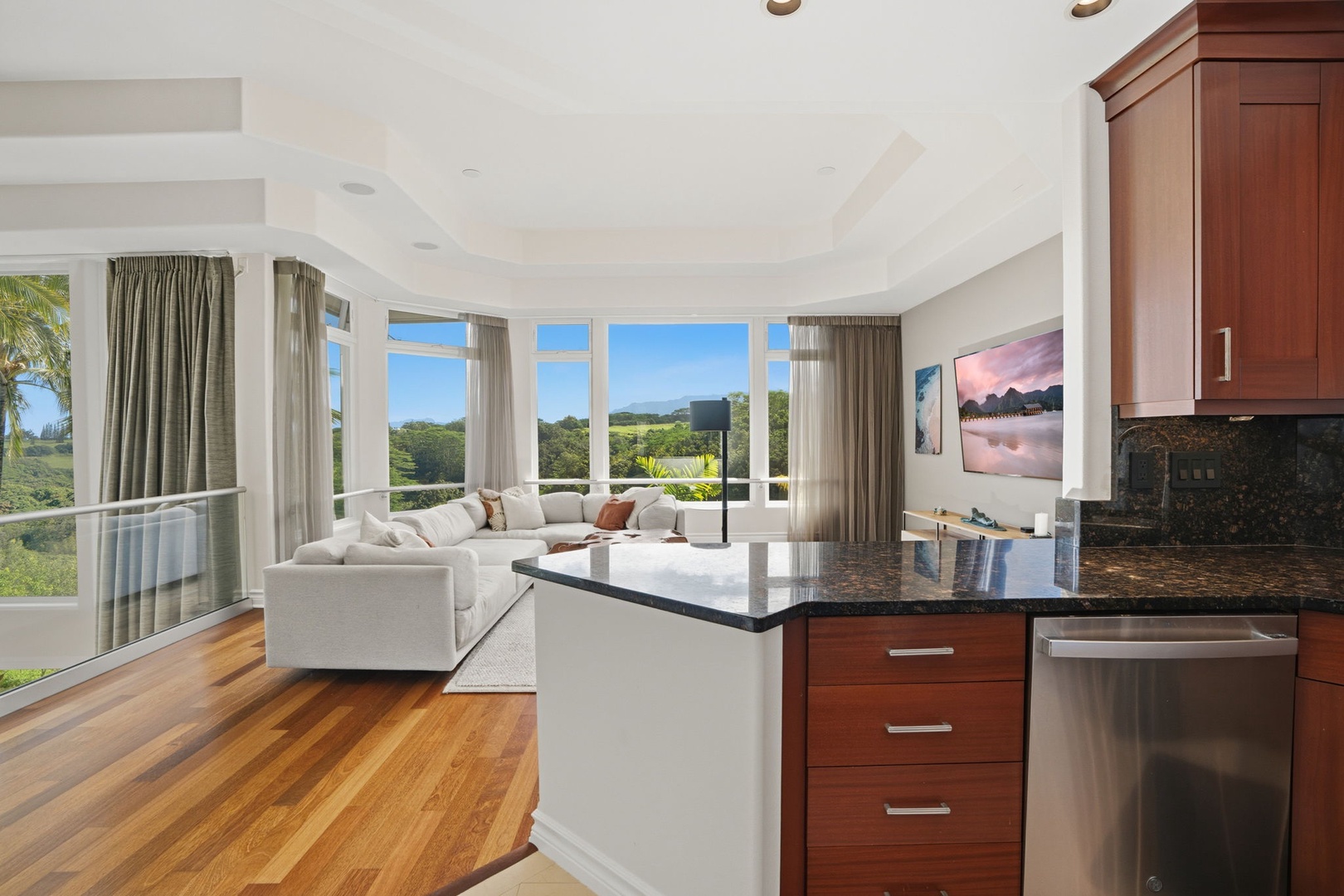 Princeville Vacation Rentals, Kaiulani #8 - Keep an eye on the view from the kitchen island while the living room fills up.