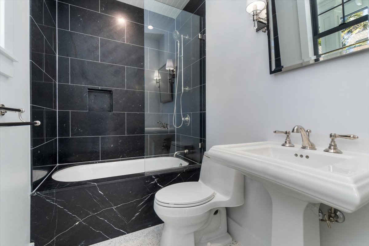 Kailua Vacation Rentals, Kailua Beachfront Estate - Bold contrast guest bath featuring dark tile and pedestal sink.