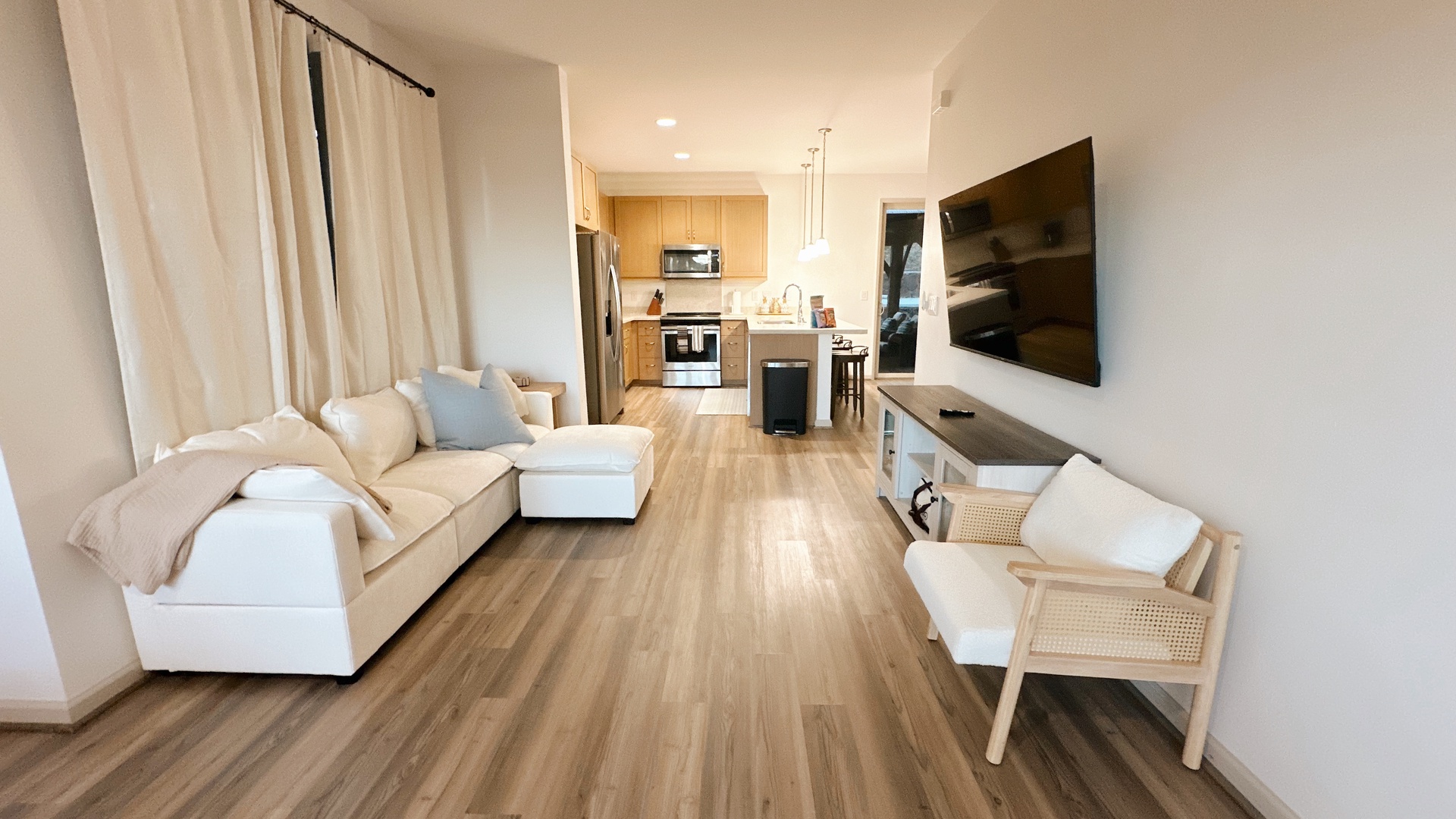 Makaha Valley Vacation Rentals, Makaha Valley Hale Kai** - Bright living area with sectional sofa and TV, opening directly into the kitchen.