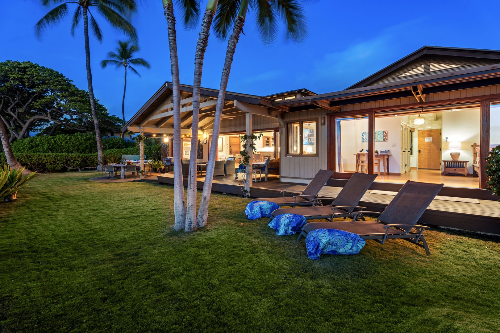 Kamuela Vacation Rentals, Island Time Retreat - Stretch out on the lawn loungers under the palms as the ocean goes quiet at dusk.
