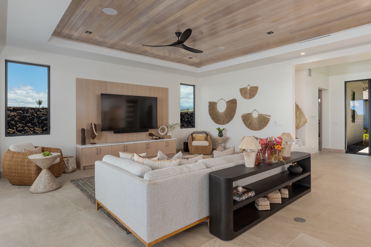 Waimea Vacation Rentals, 5BD Mauna Lani Lux Golf Estate (4) at One Ocean - This chic living room is designed with a contemporary flair, featuring a plush, sectional sofa that invites relaxation.