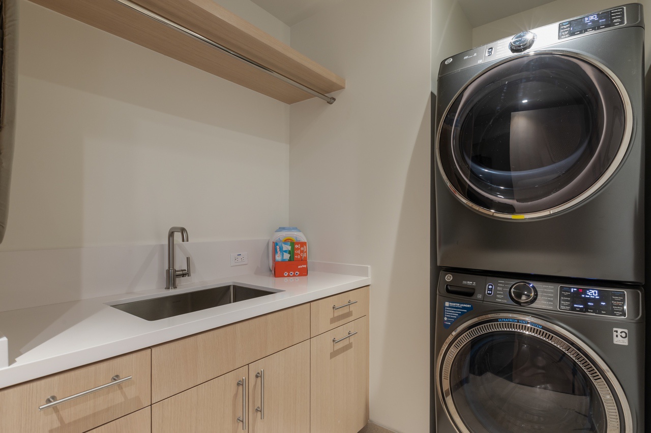 Waimea Vacation Rentals, 5BD Mauna Lani Lux Golf Estate (4) at One Ocean - This well-equipped laundry room is designed for efficiency and convenience, featuring modern appliances stacked neatly to save space.