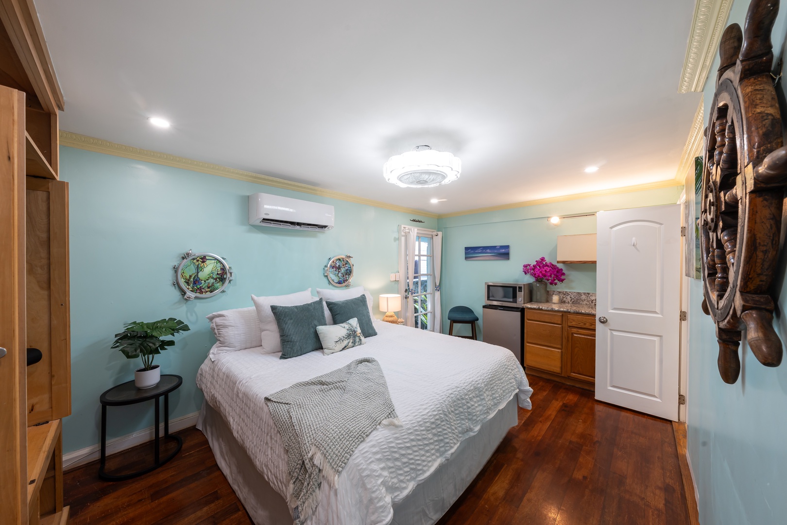 Hauula Vacation Rentals, Private Beach Paradise - A ship's wheel over the bed sets the nautical tone in this spacious bedroom.
