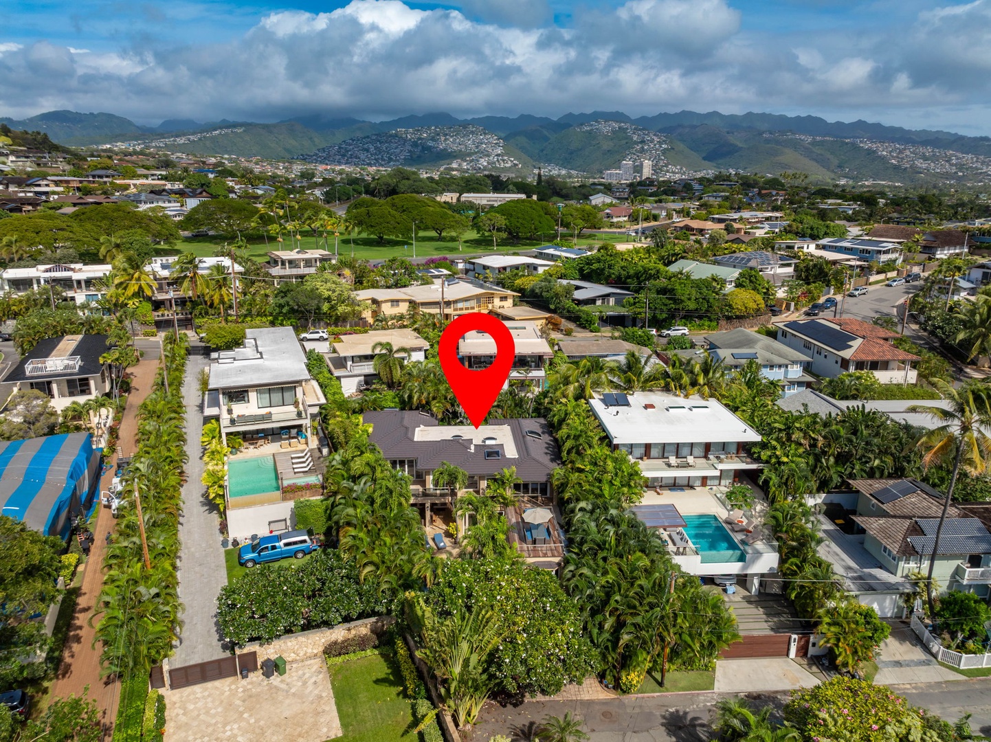 Honolulu Vacation Rentals, Diamond Head Luxe - Aerial view of a tropical residential neighborhood nestled among lush green hills and mountains.