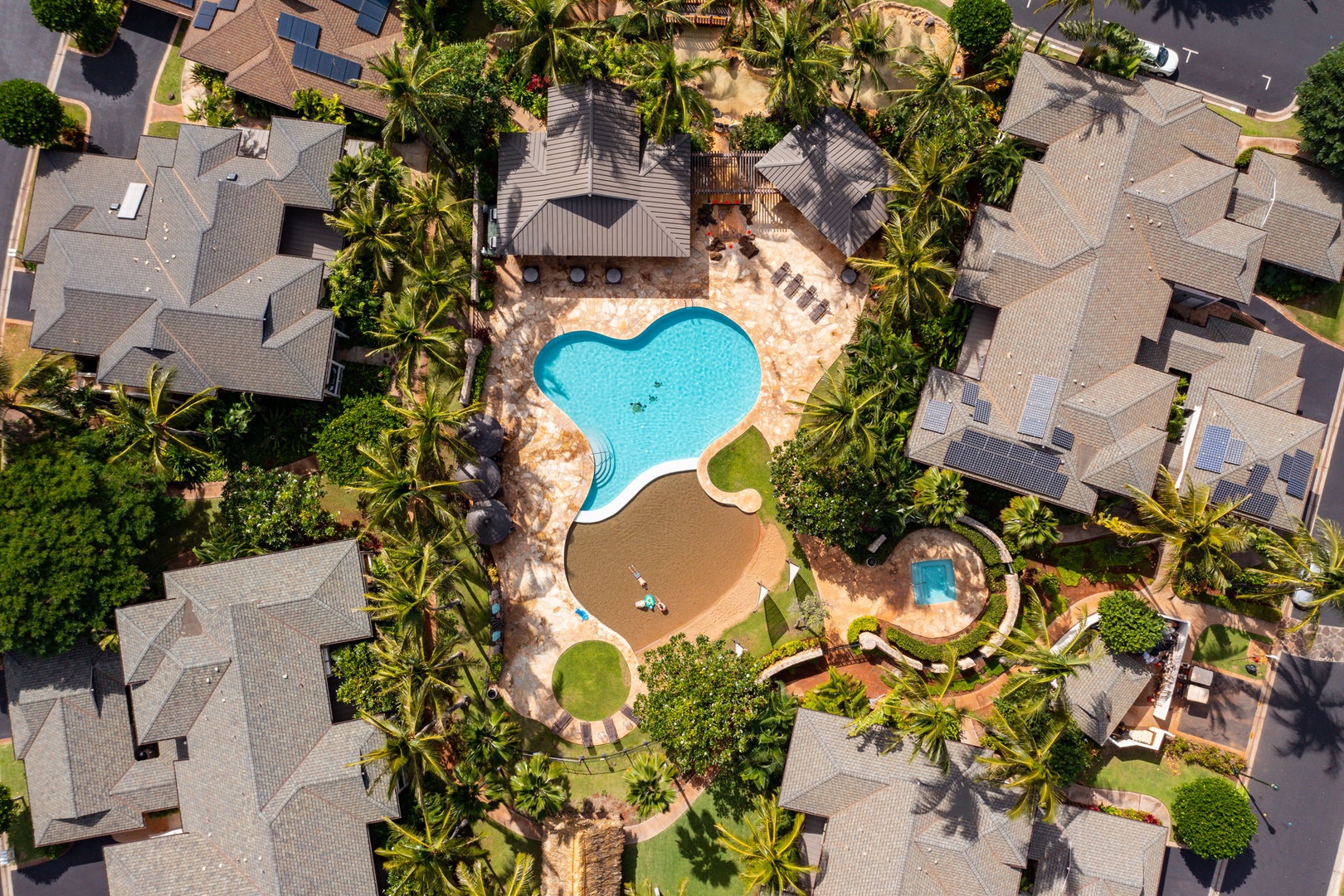 Kapolei Vacation Rentals, Coconut Plantation 1080-4 - Curved and blue, the resort pool reads like a lagoon from the air.