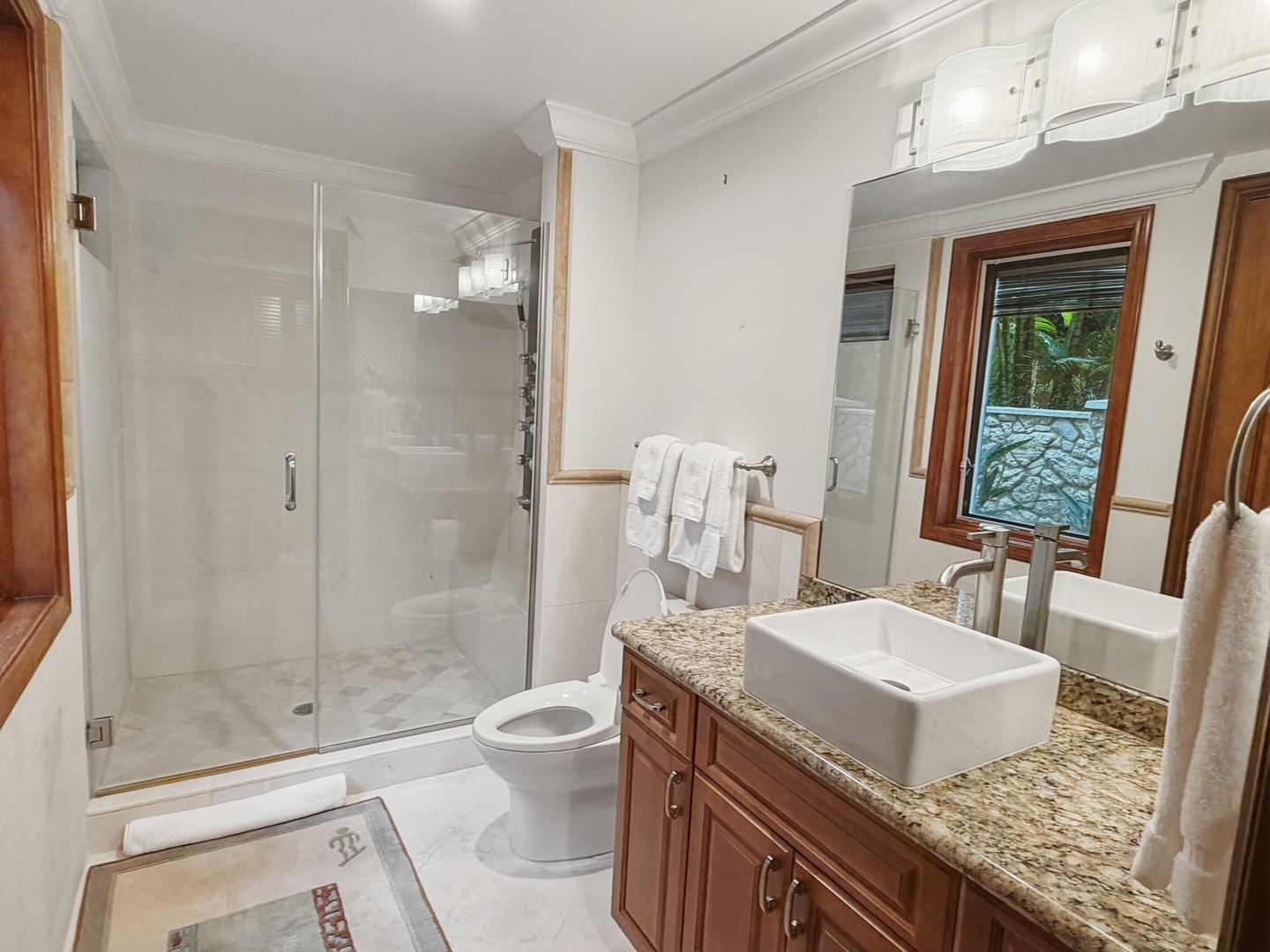 Honolulu Vacation Rentals, Maunalua Estate - Step into your luxurious marble bathroom with spacious walk-in shower, elegant granite vanity, and fresh towels waiting for you.
