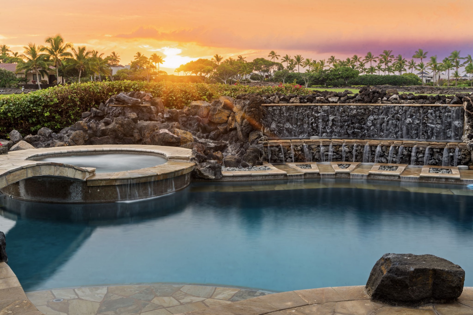 Kamuela Vacation Rentals, Hale Konane - Watch the sky ignite at dusk as the pool’s waterfall glows in the golden hour light.