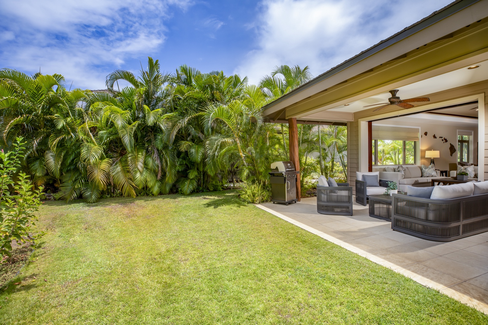 Kamuela Vacation Rentals, Mauna Lani KaMilo #503 - Let the kids play or enjoy a quiet moment in this private backyard space framed by tropical palms.
