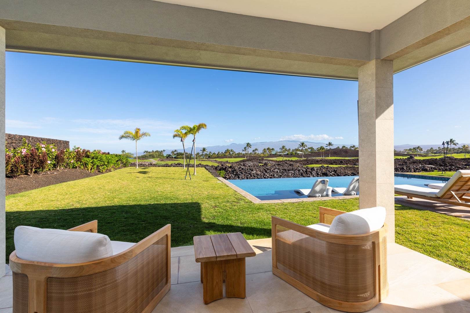 Kamuela Vacation Rentals, 5BD Mauna Lani Lux Ocean Estate (OE12) at One Ocean - Relax in your private covered lanai with stunning pool and garden views, where tropical breezes meet luxurious comfort.
